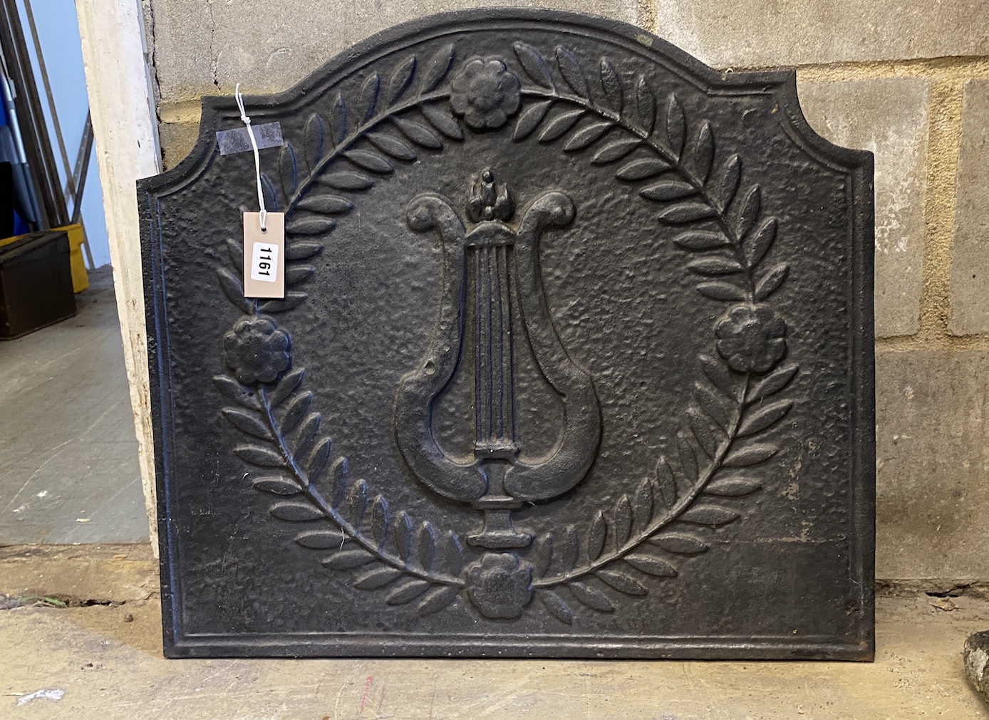 A 19th century French cast iron lyre fireback, width 60cm, height 54cm